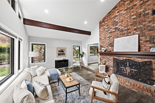 living room featuring a fireplace, wood-type flooring, high vaulted ceiling, and beamed ceiling