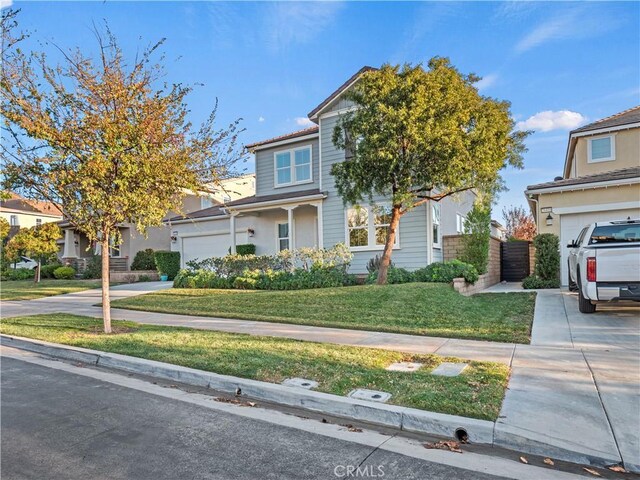 view of front of property with a garage and a front yard