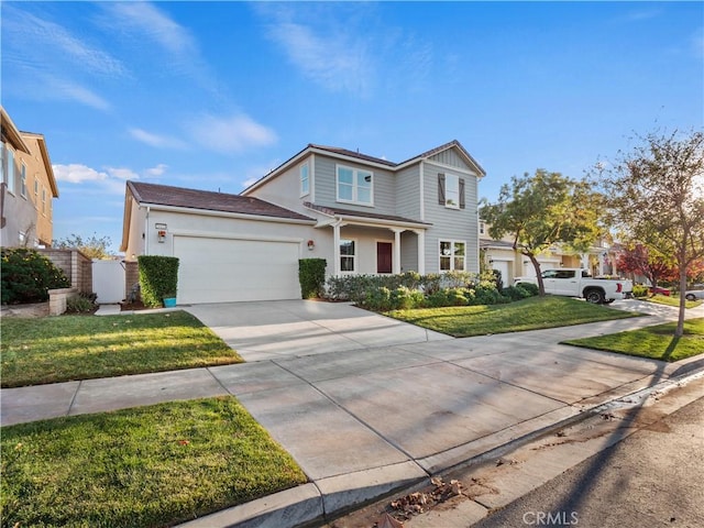 view of property featuring a garage and a front lawn