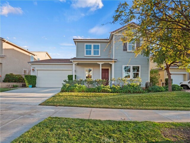 view of front of home with a garage and a front lawn