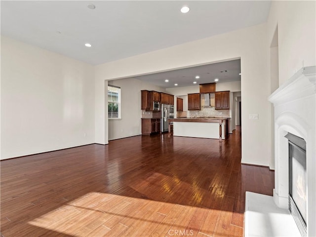 unfurnished living room with dark hardwood / wood-style floors