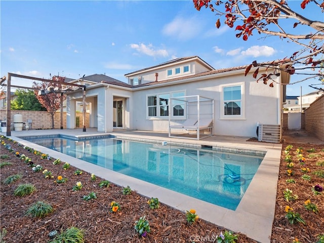 back of house featuring a fenced in pool and a patio