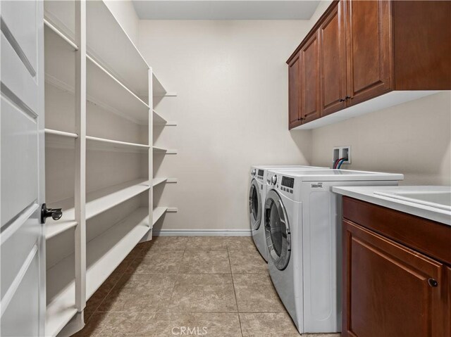 laundry room with cabinets, separate washer and dryer, and light tile patterned floors