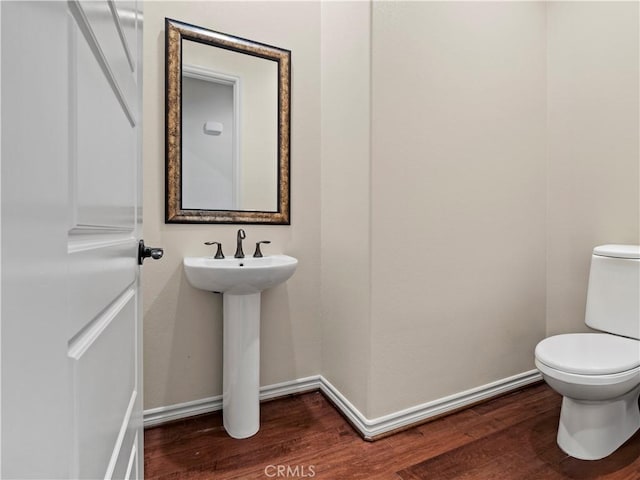 26420 Township St, Saugus, CA 91350 - half bathroom with a sink, toilet, wood finished floors, and baseboards