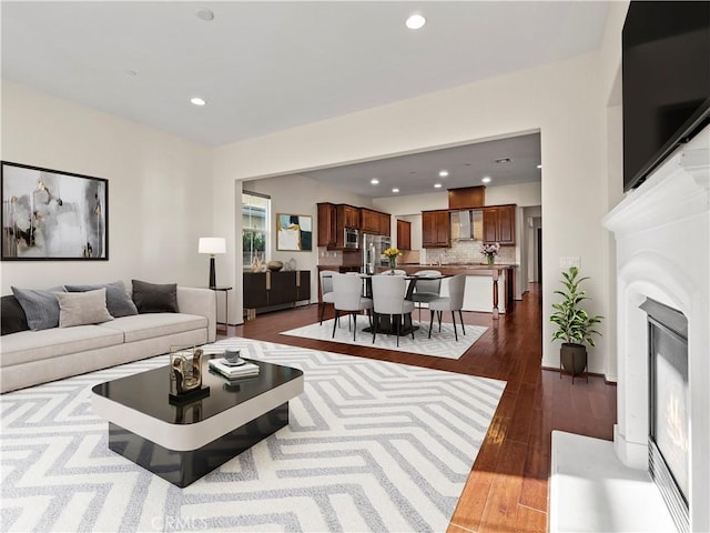 26420 Township St, Saugus, CA 91350 - living room with dark wood-type flooring, a glass covered fireplace, and recessed lighting