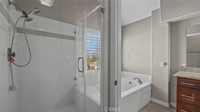 bathroom with shower with separate bathtub and vanity