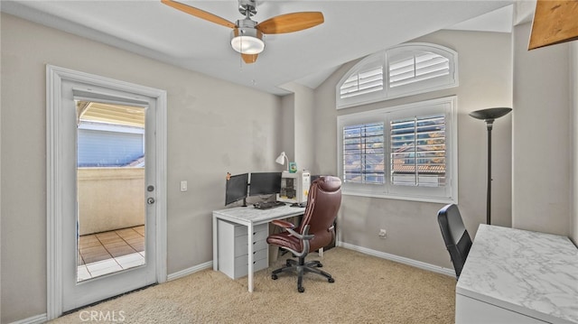 carpeted home office with vaulted ceiling, ceiling fan, and a healthy amount of sunlight