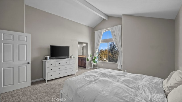 carpeted bedroom with connected bathroom and vaulted ceiling with beams