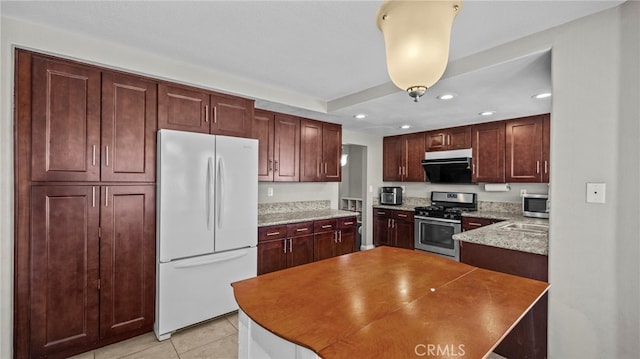 kitchen with light stone counters, light tile patterned floors, stainless steel appliances, and exhaust hood