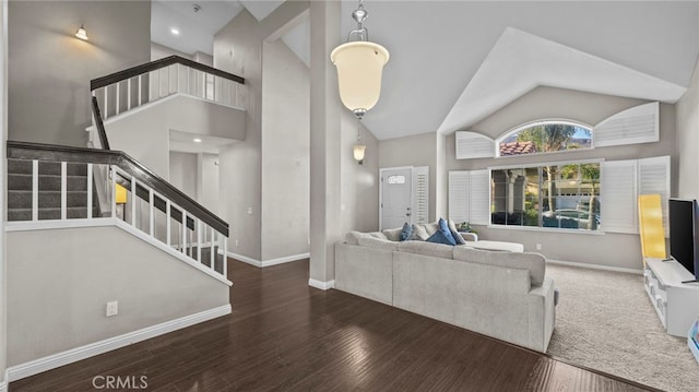 living room with high vaulted ceiling and dark wood-type flooring