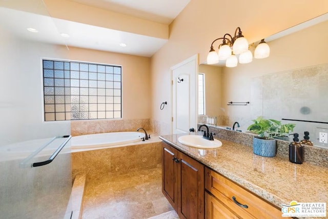 bathroom with vanity and a relaxing tiled tub