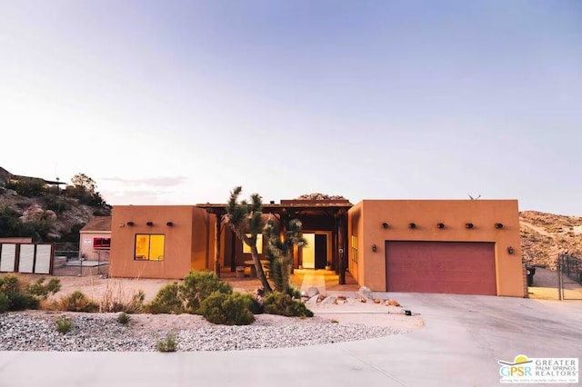 pueblo revival-style home with a garage