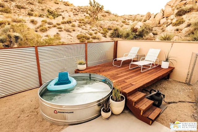 exterior space with a hot tub