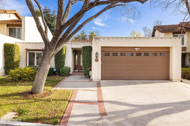 mediterranean / spanish house featuring a front yard and a garage