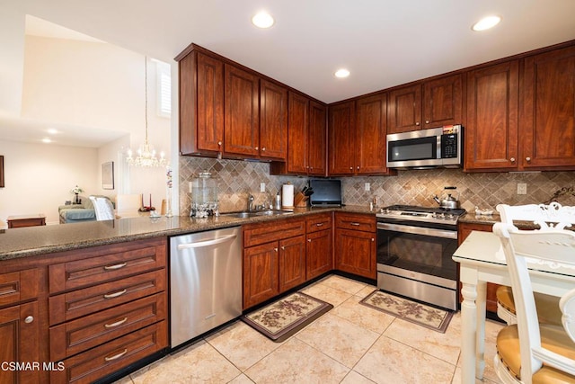 kitchen with light tile patterned floors, appliances with stainless steel finishes, sink, and tasteful backsplash