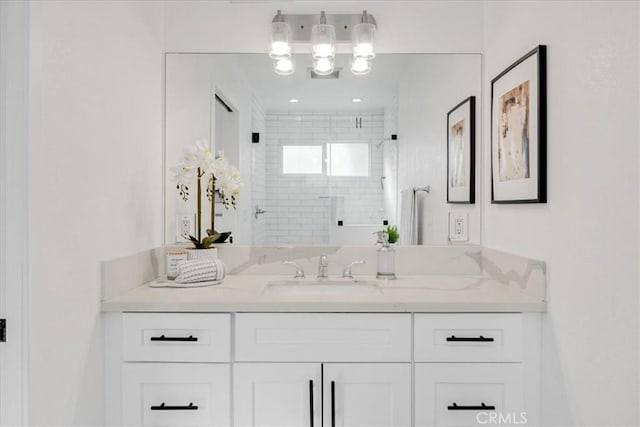 bathroom featuring vanity and an enclosed shower