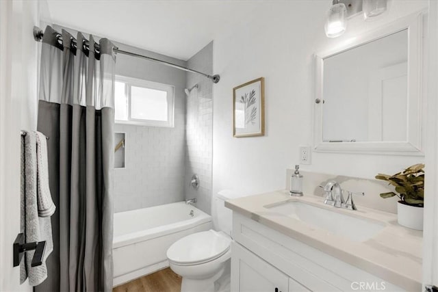 full bathroom featuring wood-type flooring, vanity, toilet, and shower / bath combo with shower curtain