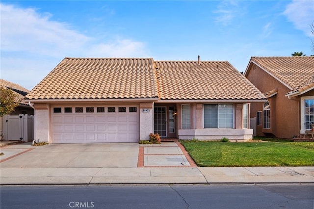 view of front of property with a front lawn and a garage