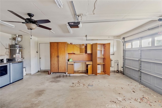 garage with washer and dryer, a garage door opener, ceiling fan, and water heater