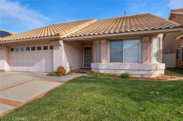 view of front of property with a garage and a front yard