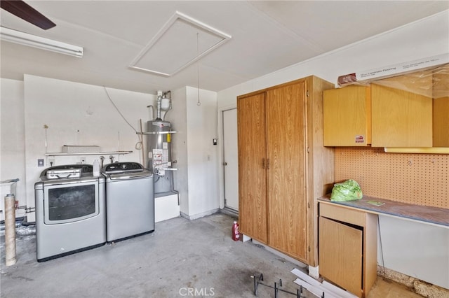 clothes washing area featuring secured water heater and washer and clothes dryer