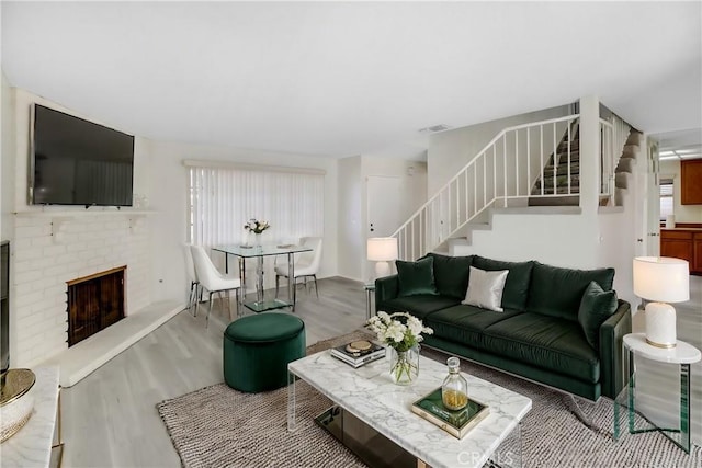 living room with a fireplace, hardwood / wood-style flooring, and plenty of natural light