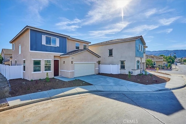 view of front of property with a mountain view and a garage