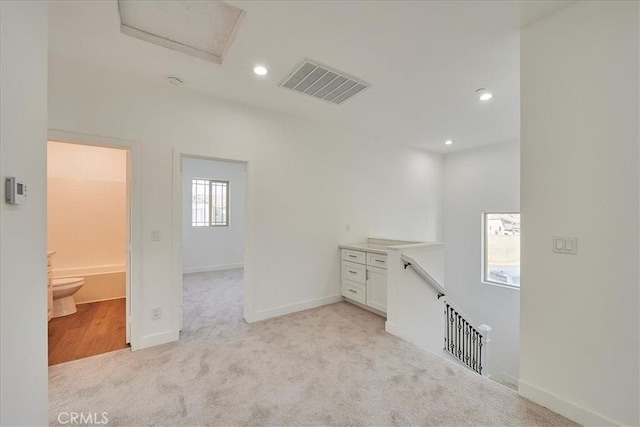 interior space with light colored carpet and a wealth of natural light