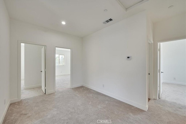 unfurnished room featuring light colored carpet