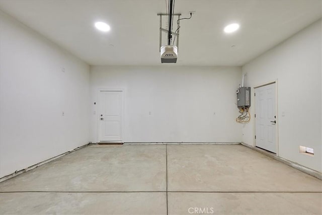 garage featuring a garage door opener and water heater