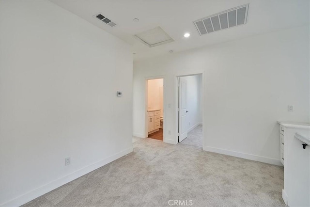 unfurnished room with light colored carpet