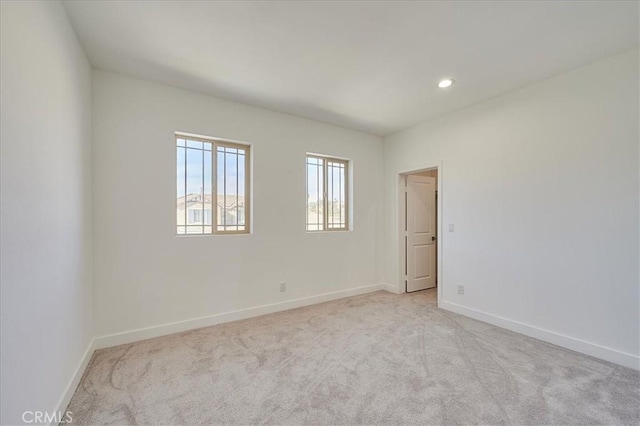 unfurnished room with light carpet