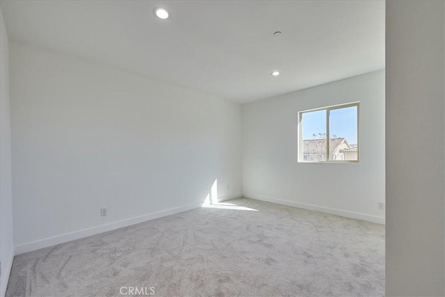 empty room featuring light carpet