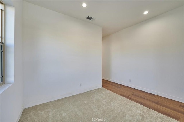 spare room with light hardwood / wood-style flooring