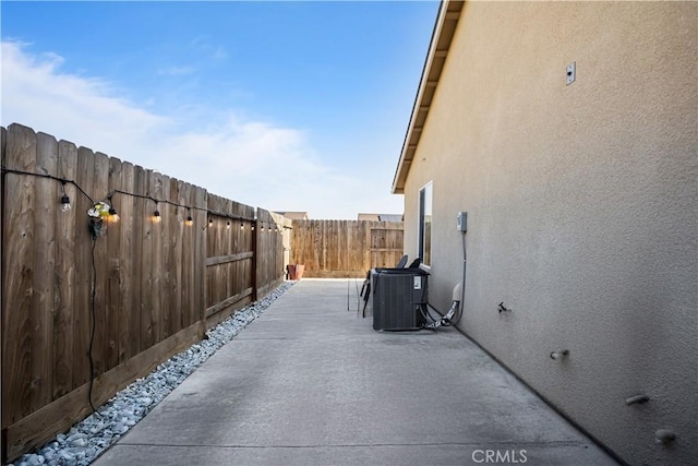 view of home's exterior with central air condition unit and a patio