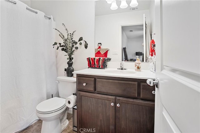 bathroom featuring toilet, vanity, and tile patterned flooring