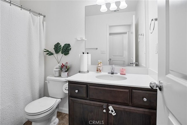 bathroom featuring toilet and vanity