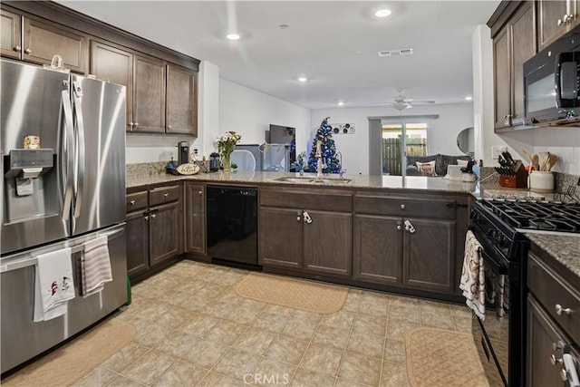 kitchen featuring black appliances, kitchen peninsula, sink, dark brown cabinetry, and light stone counters