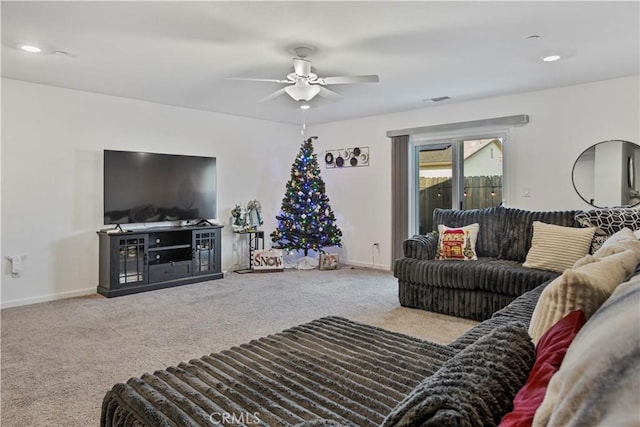 living room featuring ceiling fan and carpet