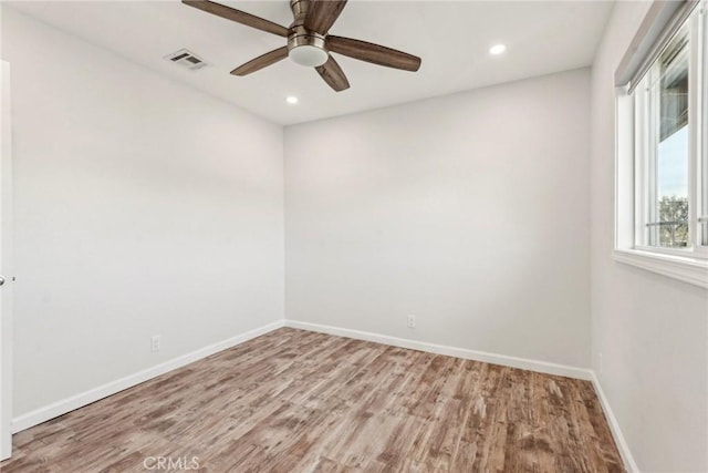 empty room with light hardwood / wood-style floors and ceiling fan