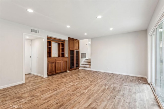 unfurnished living room with light hardwood / wood-style floors