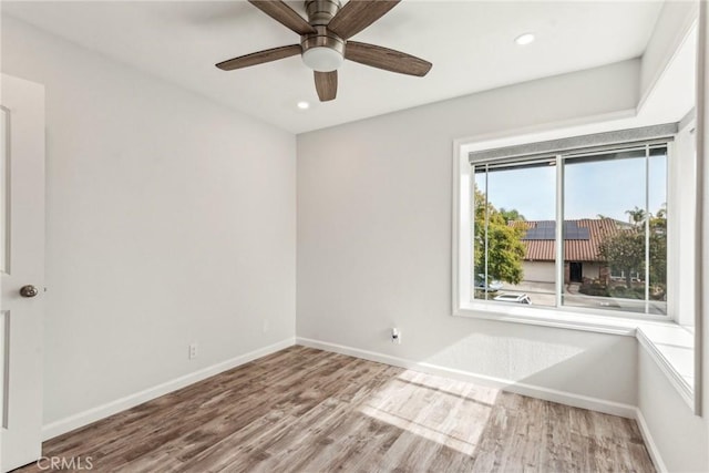 empty room featuring ceiling fan and hardwood / wood-style floors