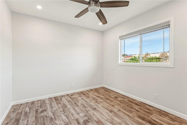 empty room featuring wood-type flooring and ceiling fan