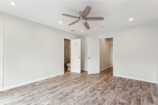 unfurnished bedroom featuring connected bathroom, ceiling fan, and light wood-type flooring