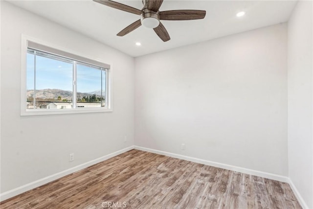 unfurnished room with wood-type flooring and ceiling fan