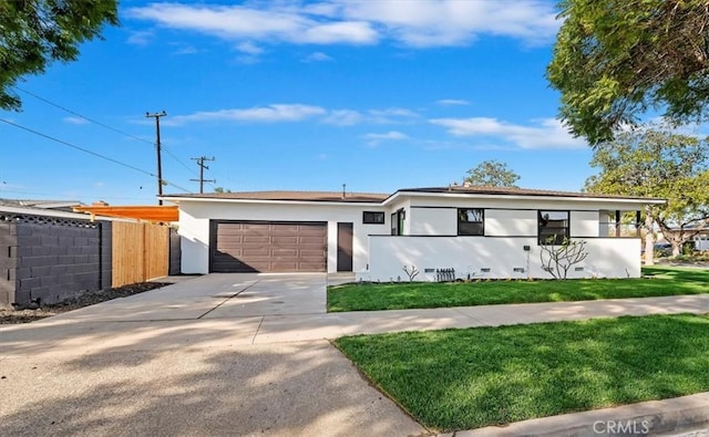 ranch-style house with a garage and a front lawn