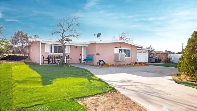 back of house featuring a yard and a garage