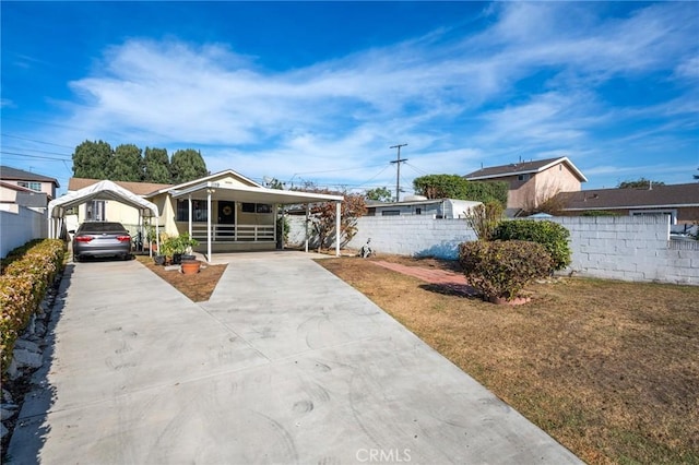 bungalow-style home featuring a front yard and a carport