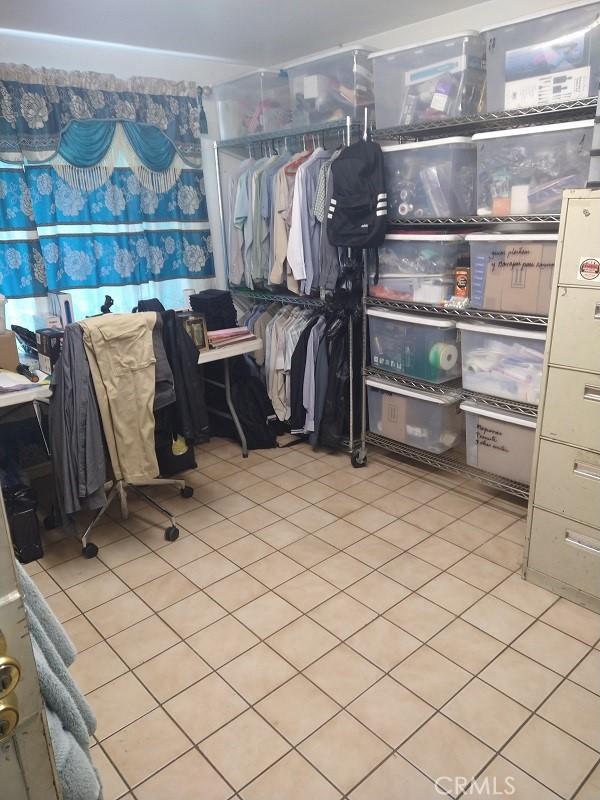 spacious closet featuring light tile patterned floors