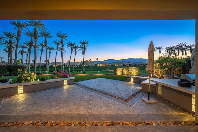 patio terrace at dusk with a mountain view